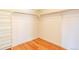 Walk-in closet with minimalist white shelving and bright hardwood floors at 8055 S Zephyr Way, Littleton, CO 80128