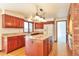 Well-equipped kitchen featuring wood cabinets, granite countertops, a center island, and a view of the backyard at 8055 S Zephyr Way, Littleton, CO 80128