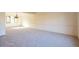 Open living space featuring light-colored carpet at 8055 S Zephyr Way, Littleton, CO 80128