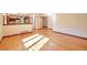 Bright and open living space with hardwood floors, views of the kitchen, and ample natural light at 8055 S Zephyr Way, Littleton, CO 80128