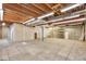 A large unfinished basement with cement floors, bright lights, and an exposed ceiling at 8055 S Zephyr Way, Littleton, CO 80128