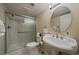 Clean bathroom features a shower over tub with a sliding door, toilet and vanity at 10441 W Remington Dr, Littleton, CO 80127