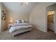 Bedroom features neutral walls, carpet, a large bed, and decor at 10441 W Remington Dr, Littleton, CO 80127
