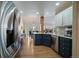 Beautiful kitchen featuring stainless steel appliances, dark blue cabinets and hardwood floors at 10441 W Remington Dr, Littleton, CO 80127