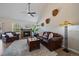 Spacious living room with hardwood floors, cozy seating, a warm fireplace, and natural light at 10441 W Remington Dr, Littleton, CO 80127