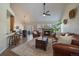 Bright and airy living room showcasing a modern ceiling fan, fireplace, and hardwood floors at 10441 W Remington Dr, Littleton, CO 80127