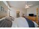 Comfortable bedroom with wood floors, a four-poster bed and a view of the ensuite bathroom at 10441 W Remington Dr, Littleton, CO 80127