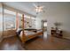 Inviting bedroom with wood floors, large windows, and a four-poster bed, offering comfort and style at 10441 W Remington Dr, Littleton, CO 80127