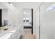 Bathroom with double vanity, walk-in shower, and barn door to bedroom at 838 N Yantley St, Aurora, CO 80018