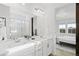 Spa-like bathroom with a double vanity, walk-in shower and plenty of natural light at 838 N Yantley St, Aurora, CO 80018