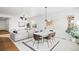 Modern dining room with a white table and brown leather chairs at 838 N Yantley St, Aurora, CO 80018
