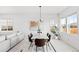 Modern dining room with white table and brown leather chairs, hardwood floor at 838 N Yantley St, Aurora, CO 80018