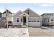 Charming craftsman style home with gray siding and a two-car garage at 838 N Yantley St, Aurora, CO 80018