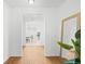Light-filled hallway with wood-look floors and mirror at 838 N Yantley St, Aurora, CO 80018