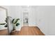 Bright hallway with wood-look floors and access to laundry at 838 N Yantley St, Aurora, CO 80018