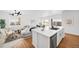 Open concept kitchen with white cabinets, island, and stainless steel appliances at 838 N Yantley St, Aurora, CO 80018