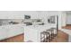 Modern kitchen with white cabinets, island, and stainless steel appliances at 838 N Yantley St, Aurora, CO 80018