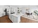 Open concept kitchen and dining area with light wood floors at 838 N Yantley St, Aurora, CO 80018