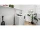 Laundry room with washer, dryer, and shelving at 838 N Yantley St, Aurora, CO 80018