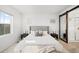 Main bedroom with a king-size bed and sliding barn door to the en-suite bathroom at 838 N Yantley St, Aurora, CO 80018