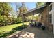 Charming backyard patio with stone pavers and a comfortable seating area next to a lush green lawn at 3767 E Phillips Cir, Centennial, CO 80122