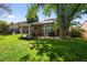 Spacious backyard featuring a lush lawn, mature trees, patio, and privacy fencing at 3767 E Phillips Cir, Centennial, CO 80122