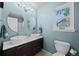 Bright bathroom with double sinks, modern fixtures, large mirror and natural light from the window at 3767 E Phillips Cir, Centennial, CO 80122