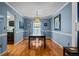 Stylish dining room with a modern chandelier, hardwood floors, and ample natural light for a comfortable dining experience at 3767 E Phillips Cir, Centennial, CO 80122