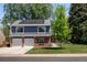 Lovely home featuring solar panels and a driveway leading to the two-car garage, surrounded by lush greenery at 3767 E Phillips Cir, Centennial, CO 80122