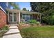 Inviting front porch with brick accents and a garden area, perfect for enjoying the outdoors at 3767 E Phillips Cir, Centennial, CO 80122