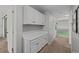 Hallway with neutral paint, carpet, built-in cabinets, and access to other rooms at 3767 E Phillips Cir, Centennial, CO 80122