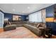 Spacious living room with a large sectional sofa, plush rug, and ambient lighting, ideal for relaxation and entertaining at 3767 E Phillips Cir, Centennial, CO 80122
