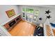 Aerial view of living room with fireplace, hardwood floors, and view of backyard through large windows at 3767 E Phillips Cir, Centennial, CO 80122