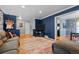 Comfortable living room with hardwood floors, ample seating, and open access to the dining area and staircase at 3767 E Phillips Cir, Centennial, CO 80122