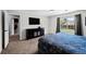 Main bedroom featuring neutral walls, carpeted floors, and a view of the yard from the window at 3767 E Phillips Cir, Centennial, CO 80122