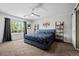 Comfortable main bedroom with a ceiling fan, decorative shelving, and a peaceful window view at 3767 E Phillips Cir, Centennial, CO 80122