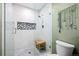 Modern glass enclosed shower with white marble tiling, mosaic tile accent, and a built-in niche at 3767 E Phillips Cir, Centennial, CO 80122