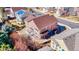 Aerial view showcasing a property with a deck, fenced yard, lush greenery, and surrounding neighborhood at 22678 E Lake Pl, Centennial, CO 80015