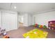 Finished basement play area with carpet, recessed lighting and ample storage at 22678 E Lake Pl, Centennial, CO 80015