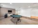 Finished basement with TV, poker table, and an open floor plan for entertaining at 22678 E Lake Pl, Centennial, CO 80015