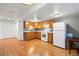 Basement kitchen with updated cabinets, flooring, white appliances, and ample lighting at 22678 E Lake Pl, Centennial, CO 80015