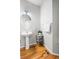 Charming half bathroom with a pedestal sink, wood floors, and neutral wall colors at 22678 E Lake Pl, Centennial, CO 80015