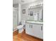 Bathroom featuring a walk-in shower, toilet, vanity, and mirror at 22678 E Lake Pl, Centennial, CO 80015