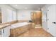 Bathroom featuring a soaking tub, tiled floors, and glass-enclosed shower stall at 22678 E Lake Pl, Centennial, CO 80015