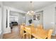 Spacious dining room featuring hardwood floors, stylish chandelier and a sunny window at 22678 E Lake Pl, Centennial, CO 80015