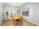 Bright dining room featuring hardwood floors, stylish chandelier, french doors and a sunny window at 22678 E Lake Pl, Centennial, CO 80015