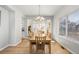 Bright dining room featuring hardwood floors, stylish chandelier, french doors and a sunny window at 22678 E Lake Pl, Centennial, CO 80015