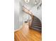 Bright foyer featuring a curved staircase, hardwood floors, and open access to other rooms at 22678 E Lake Pl, Centennial, CO 80015