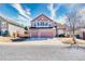 Beautiful two-story home featuring stone accents, three car garage, and meticulous landscaping at 22678 E Lake Pl, Centennial, CO 80015