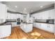 Contemporary kitchen featuring white cabinets, modern appliances, and a center island at 22678 E Lake Pl, Centennial, CO 80015